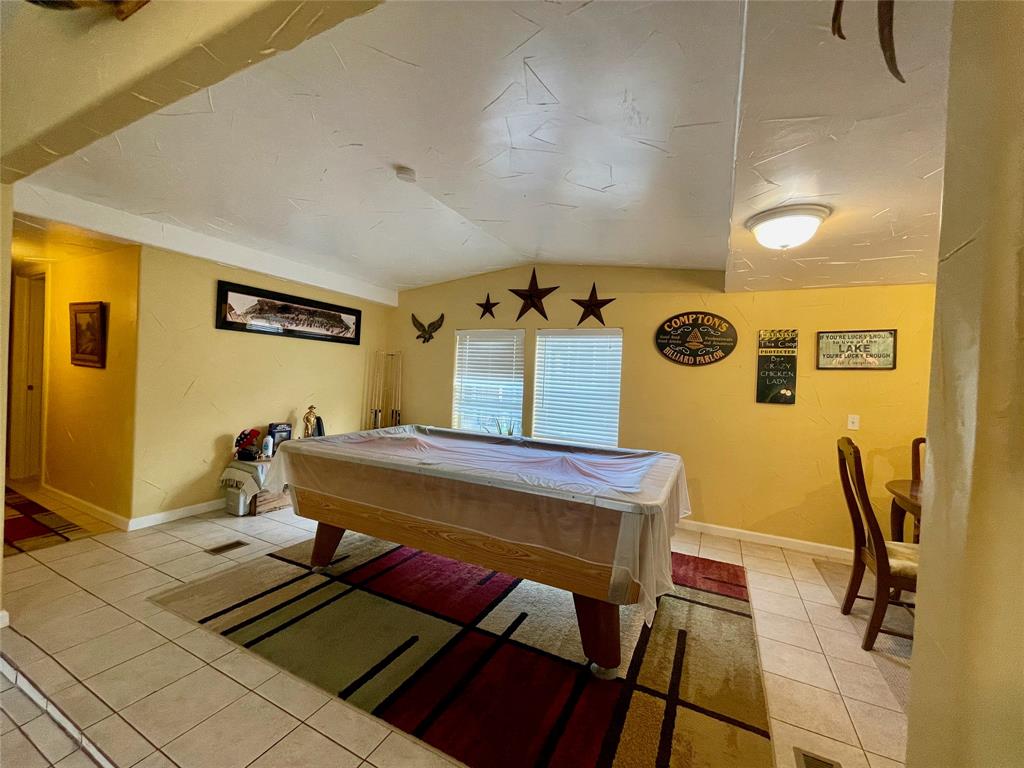 2334 San Bar Road, Unit 13 Graford, TX 76449 - Photo 5 of 33 a bedroom with a bed and wooden floor