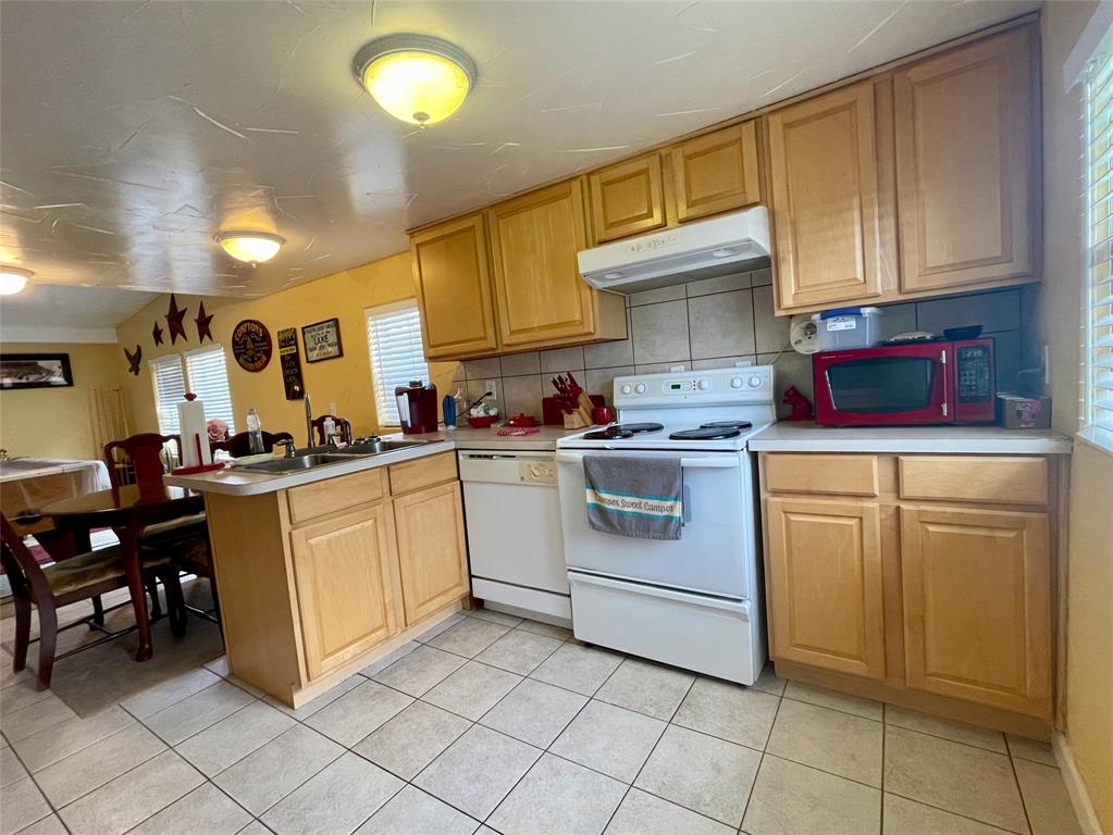2334 San Bar Road, Unit 13 Graford, TX 76449 - Photo 10 of 33 a kitchen with cabinets and white appliances
