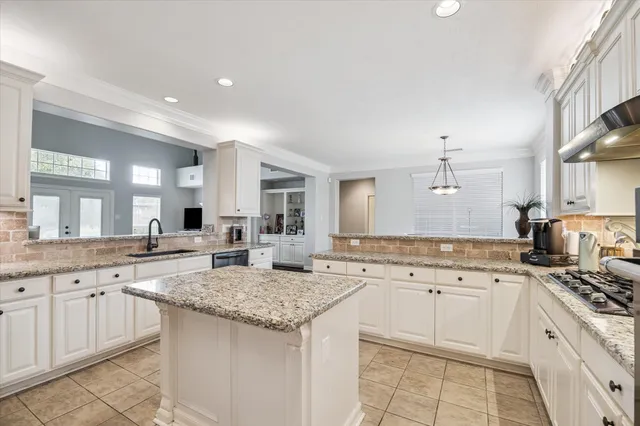 a kitchen with a sink stove and cabinets