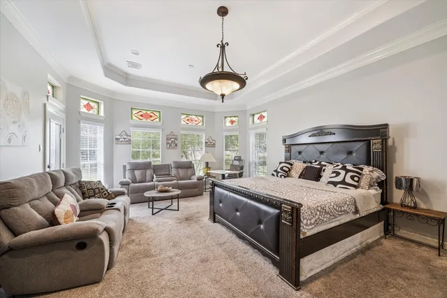 a bedroom with a bed couch and window