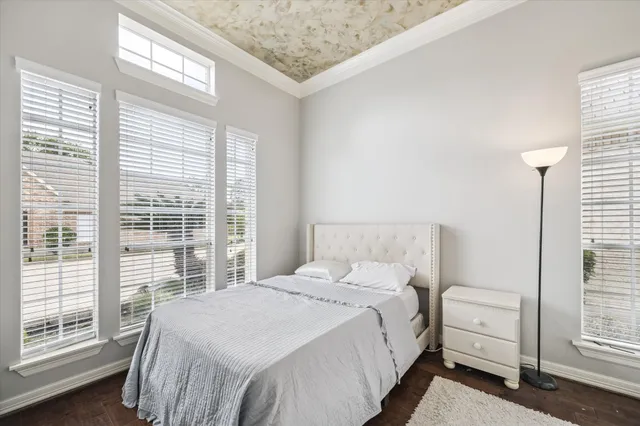 a bedroom with a bed and a large window with outer view