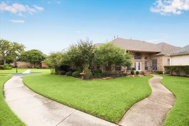 a view of a house with garden and a patio