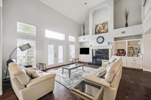 a living room with furniture a clock on wall and a fireplace