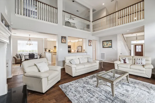 a living room with furniture a rug and a table