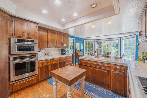 a dining room with furniture wooden floor a rug and a large window