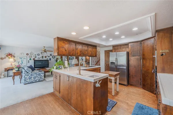 a kitchen with stainless steel appliances granite countertop a refrigerator and a stove
