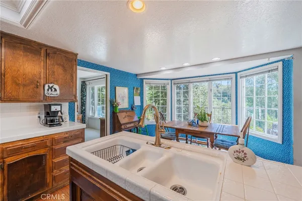 a bedroom with a bed and a couch with large mirror