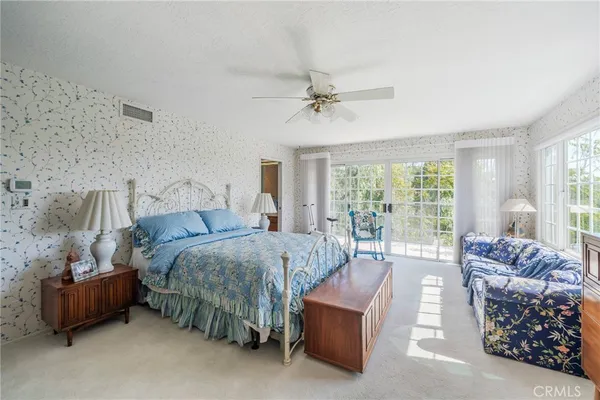 a book shelf with lounge chair in front of a door