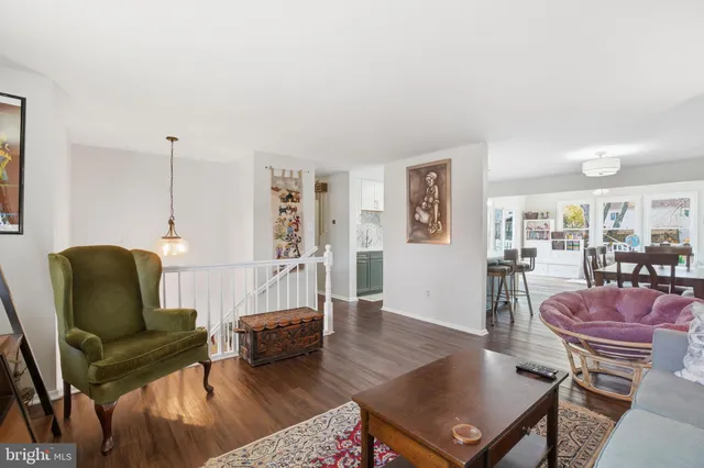 a living room with furniture rug and wooden floor