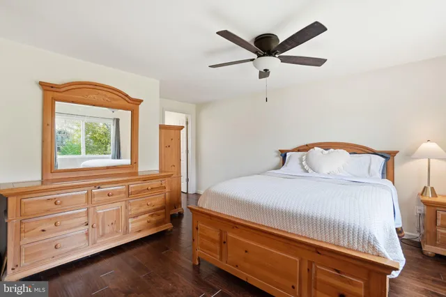 a spacious bedroom with a large bed and a large window