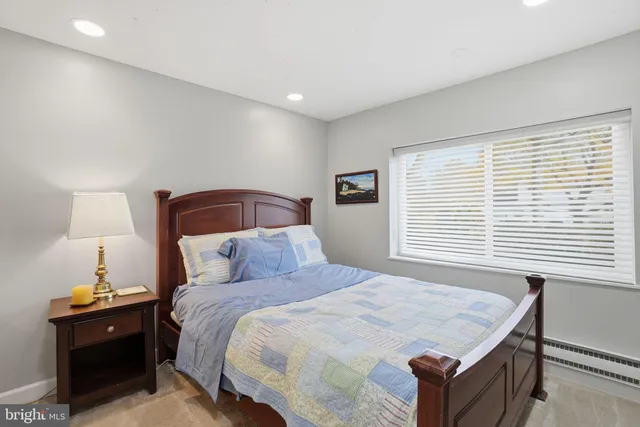 a bedroom with a bed and a table in it