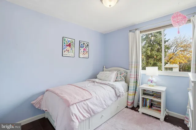 a bedroom with a bed and a book shelf
