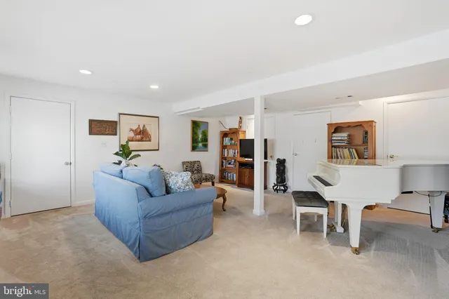 a living room with furniture a couch and painting on the wall