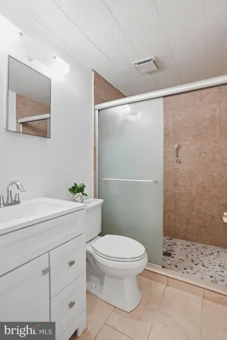 a view of a chair and fire pit in the backyard