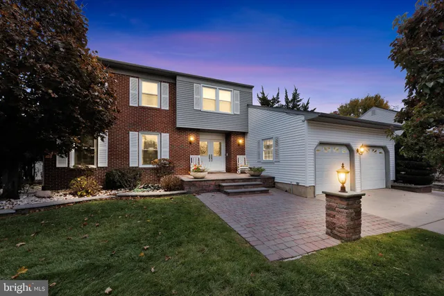 a front view of a house with a yard fire pit and outdoor seating