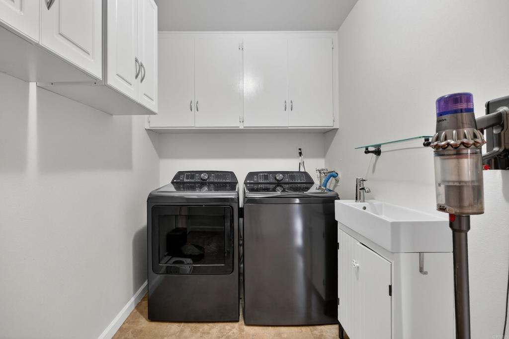 9908 West Lilac Road Escondido, CA 92026 - Photo 23 of 41 Large laundry room with built-in storage and sink