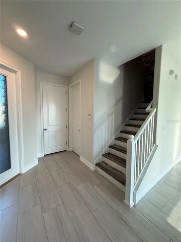 a view of a livingroom with wooden floor and stairs