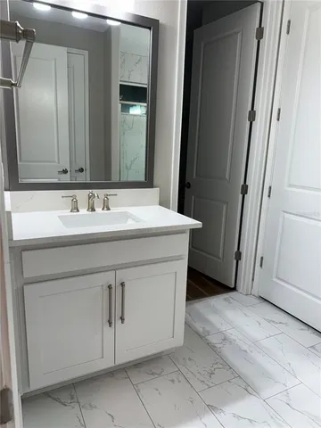 a bathroom with a sink and a mirror