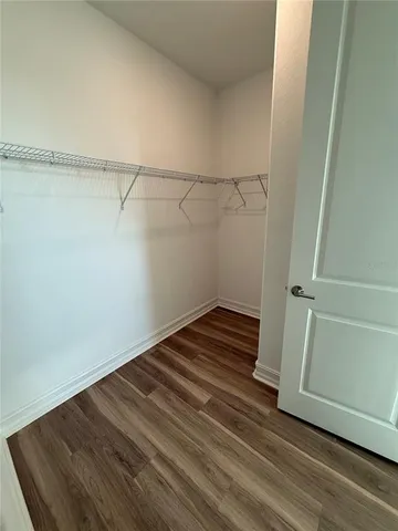 a view of a room with wooden floor