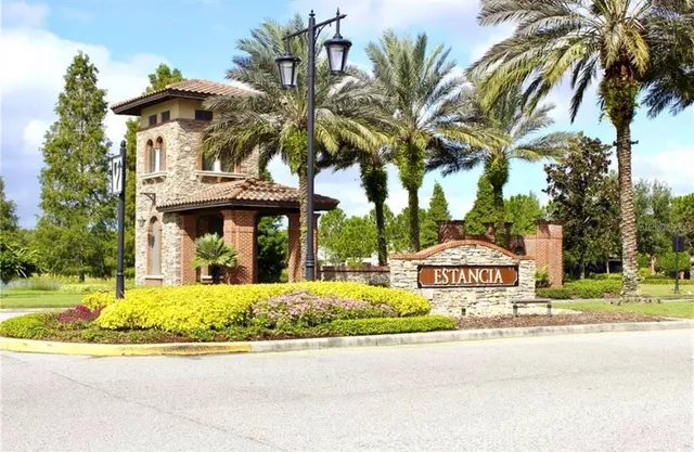 a front view of a house with yard and green space