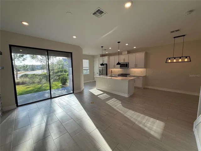 a view of a kitchen with a sink and a large window