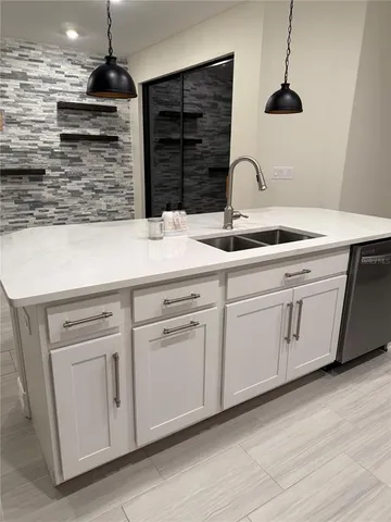 a kitchen with stainless steel appliances granite countertop a sink and cabinets