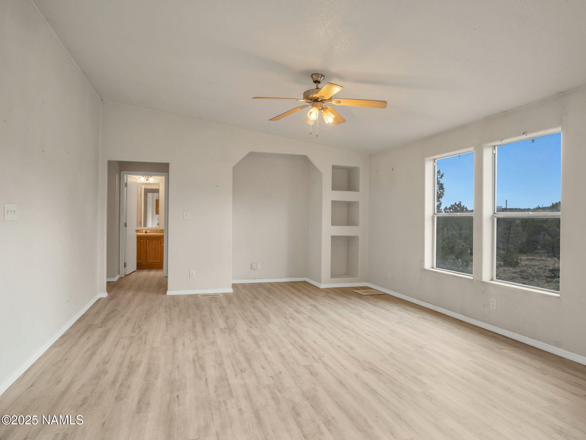 6512 North Santa Fe Road Williams, AZ 86046 - Photo 11 of 35 a view of an empty room with a window and wooden floor