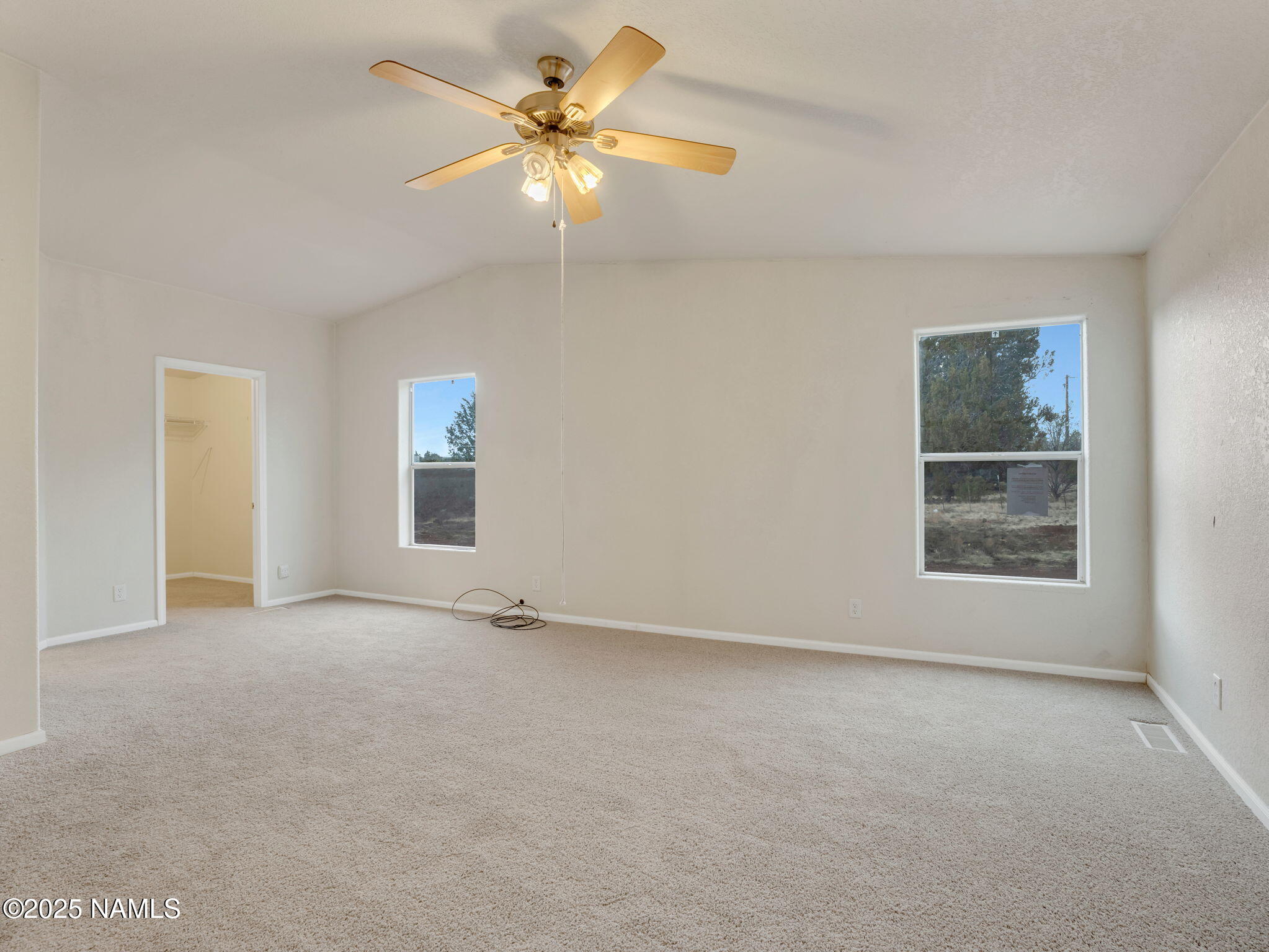 6512 North Santa Fe Road Williams, AZ 86046 - Photo 13 of 35 an empty room with windows and fan