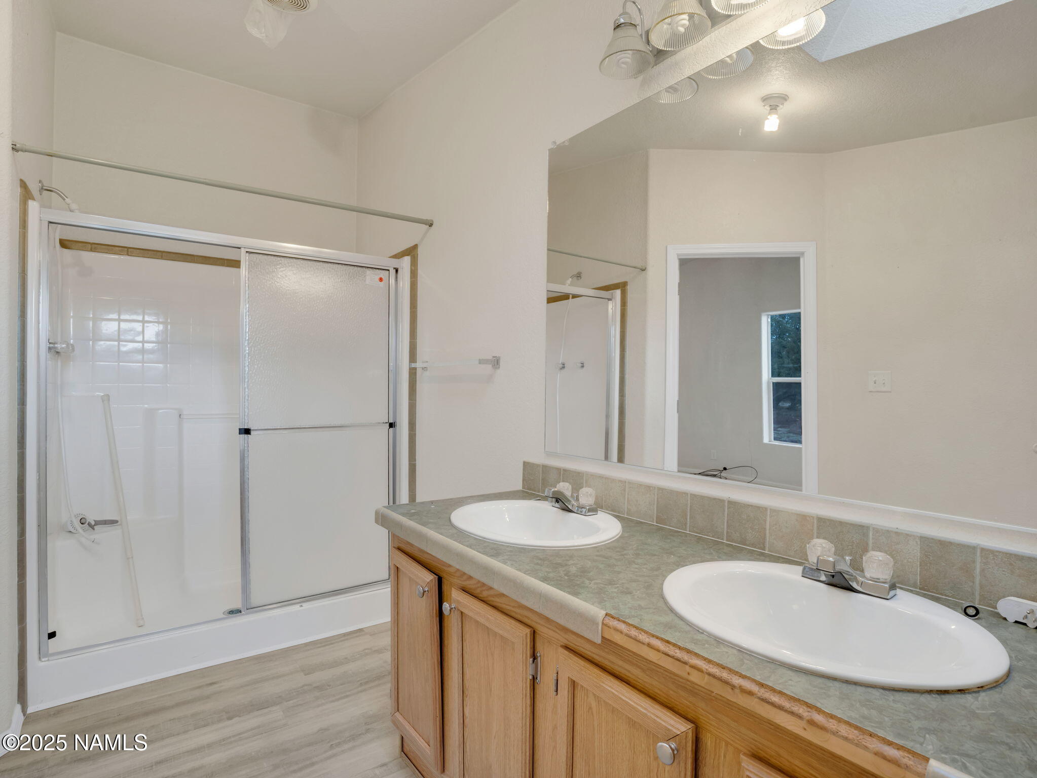 6512 North Santa Fe Road Williams, AZ 86046 - Photo 14 of 35 a bathroom with a granite countertop sink and a mirror
