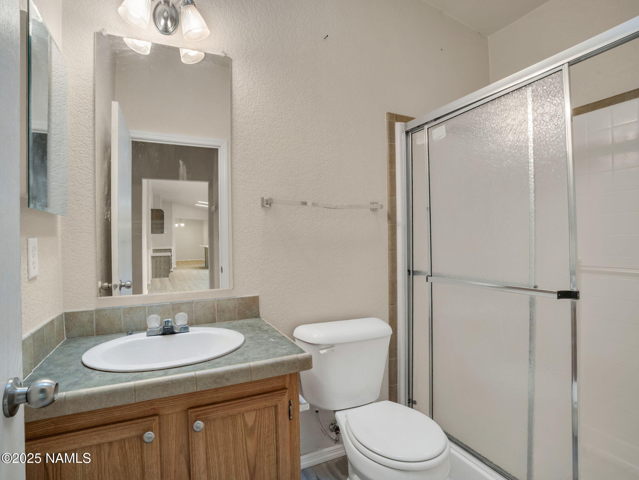 6512 North Santa Fe Road Williams, AZ 86046 - Photo 18 of 35 a bathroom with a sink toilet a mirror and shower
