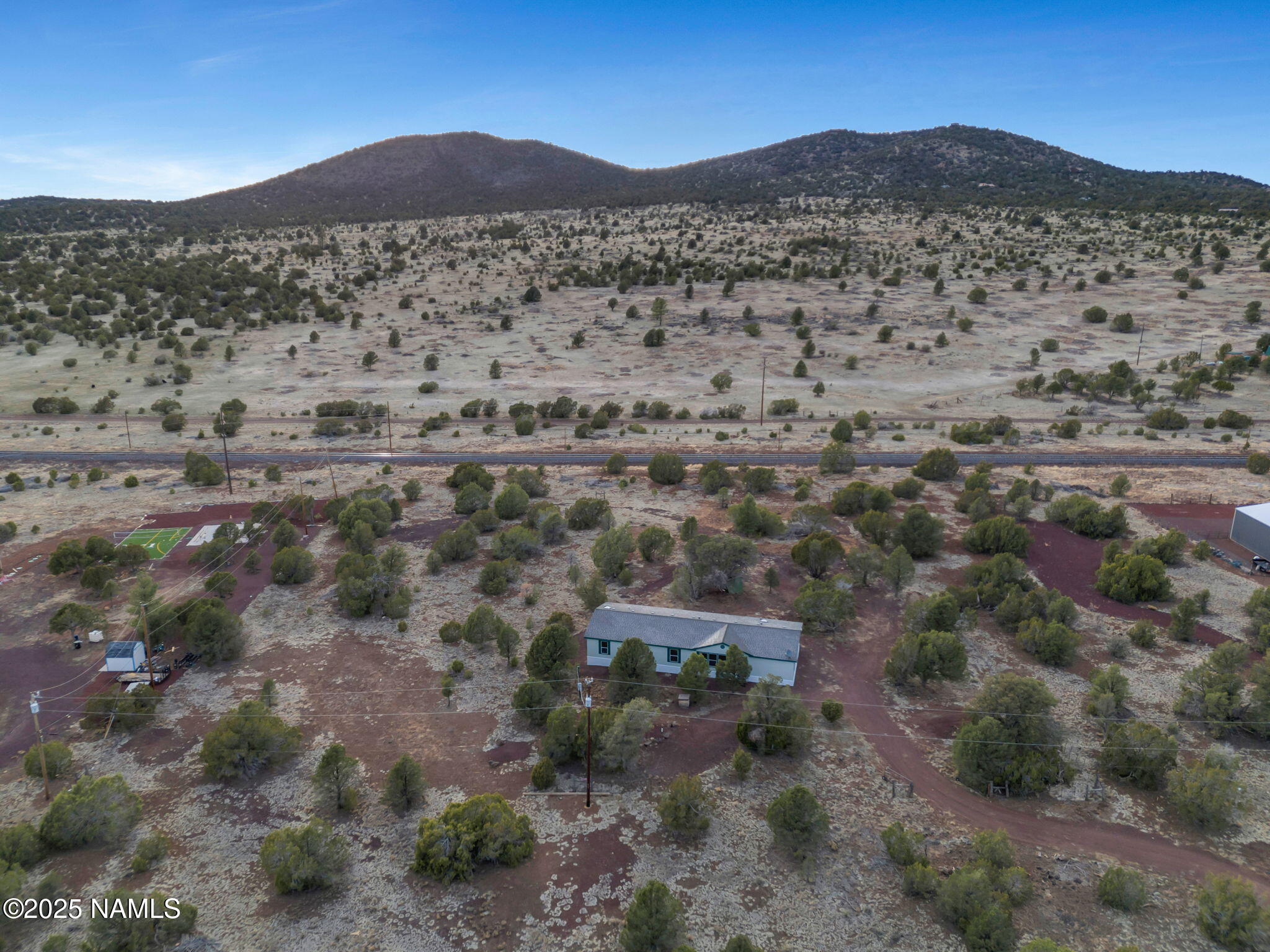 6512 North Santa Fe Road Williams, AZ 86046 - Photo 30 of 35 a view of a large mountain with trees in the background