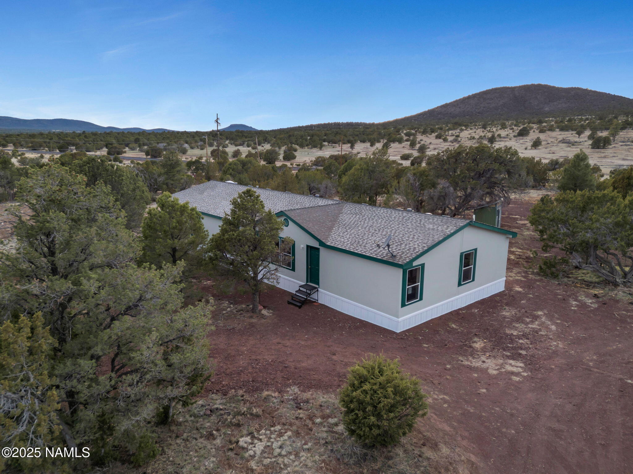 6512 North Santa Fe Road Williams, AZ 86046 - Photo 3 of 35 a view of a house with a mountain in the background