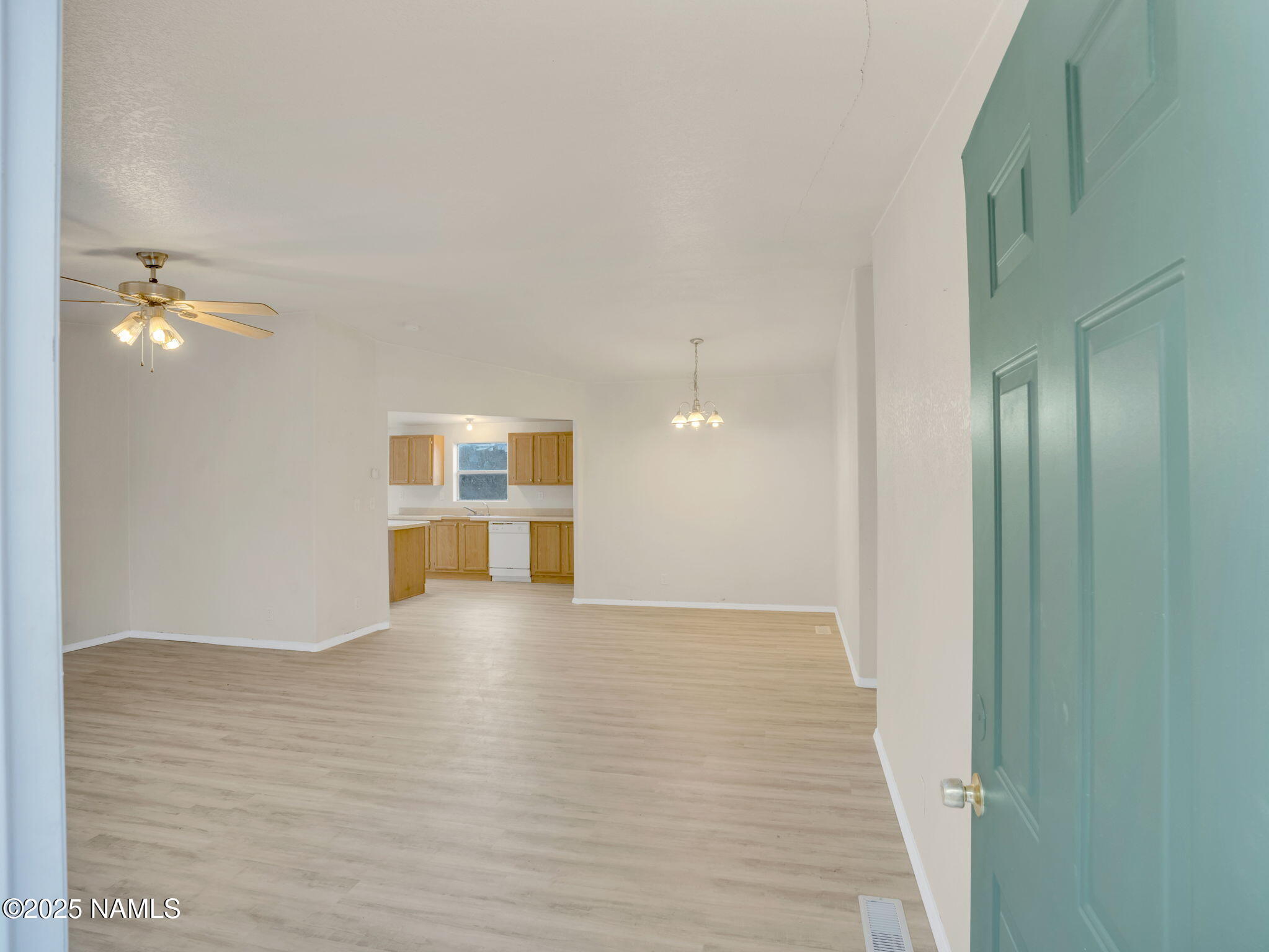 6512 North Santa Fe Road Williams, AZ 86046 - Photo 4 of 35 a view of an empty room with wooden floor and a window