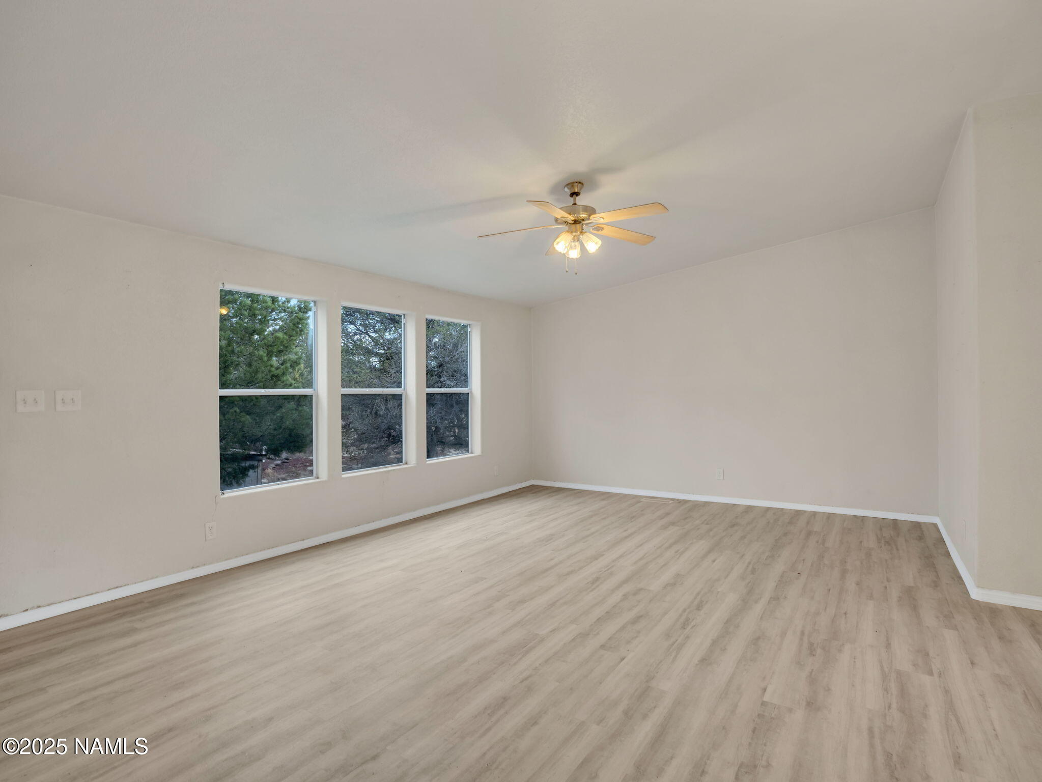 6512 North Santa Fe Road Williams, AZ 86046 - Photo 6 of 35 a view of an empty room with a window and wooden floor