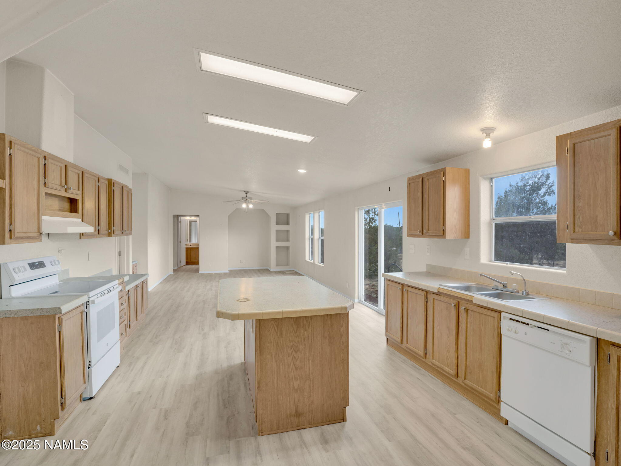 6512 North Santa Fe Road Williams, AZ 86046 - Photo 8 of 35 a large kitchen with stainless steel appliances lots of counter space and wooden floor