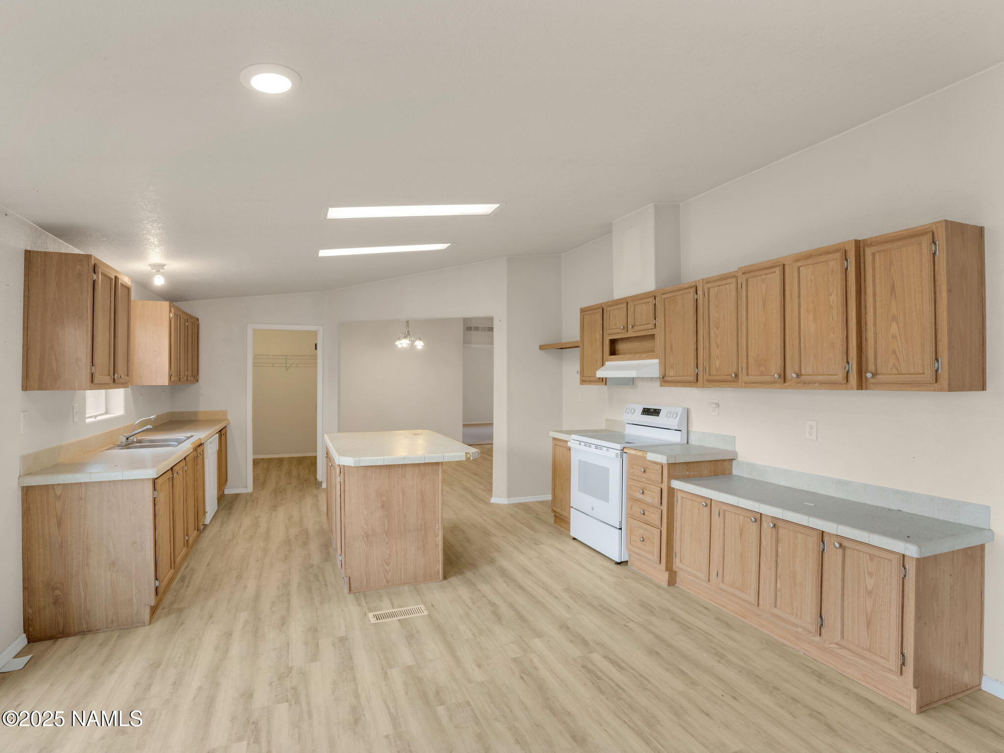 6512 North Santa Fe Road Williams, AZ 86046 - Photo 9 of 35 a large kitchen with a lot of cabinets a sink and wooden floor