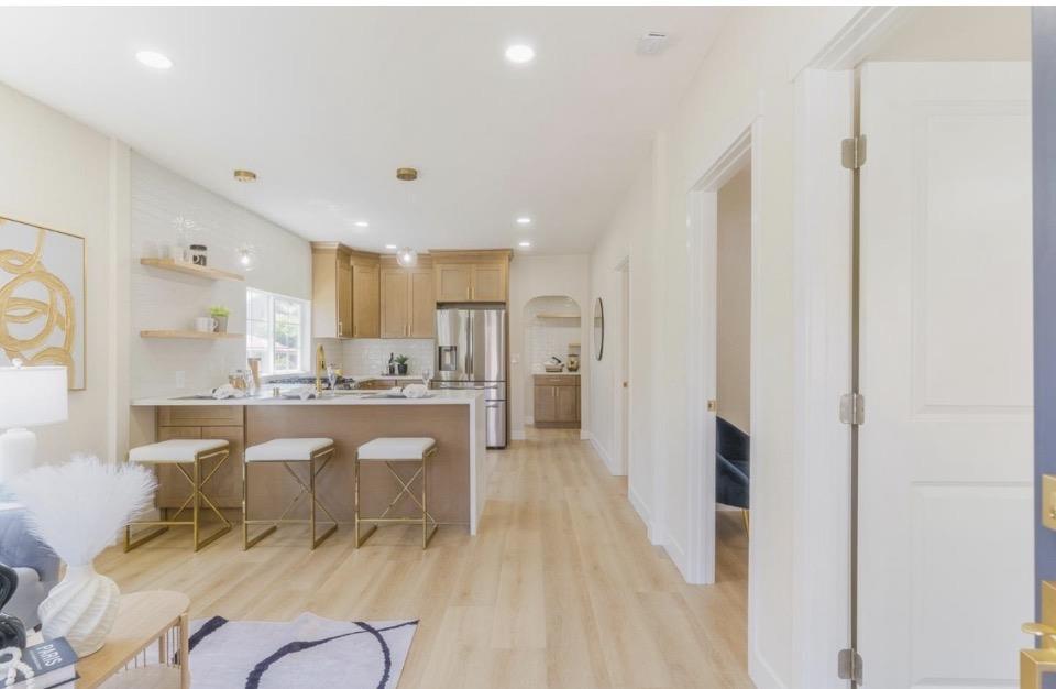 735 Locust Street San Jose, CA 95110 - Photo 5 of 21 a living room with stainless steel appliances kitchen island granite countertop furniture and a refrigerator