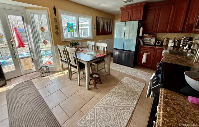 a dining room with furniture and a window