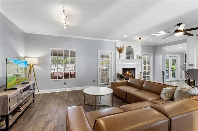 a living room with furniture a fireplace and a flat screen tv