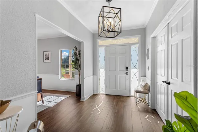 a view of a hallway with wooden floor and cabinet