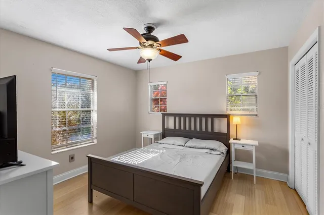 a bedroom with a bed and a window