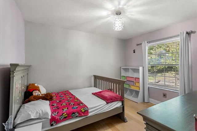 a bedroom with a bed and a chandelier