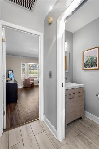 a view of a bedroom with a furniture and wooden floor