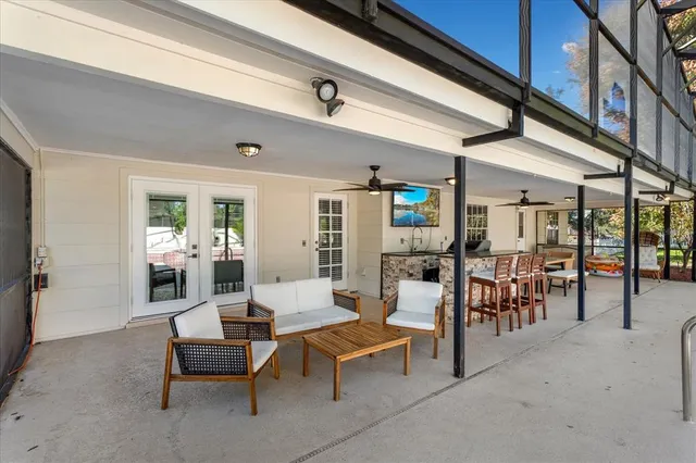 a living room with lots of furniture and lots of tables