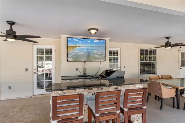 a living room with furniture a window and a flat screen tv