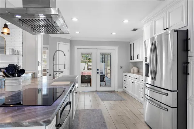a kitchen with stainless steel appliances a refrigerator sink and cabinets