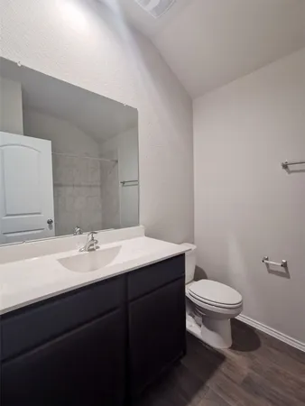 a bathroom with a sink a toilet a mirror and vanity