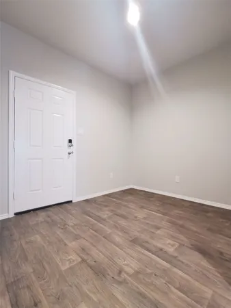 a view of an empty room and wooden floor