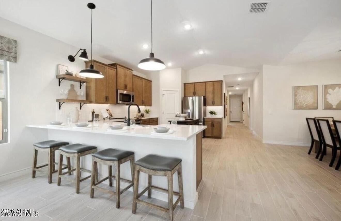 a large kitchen with a table and chairs
