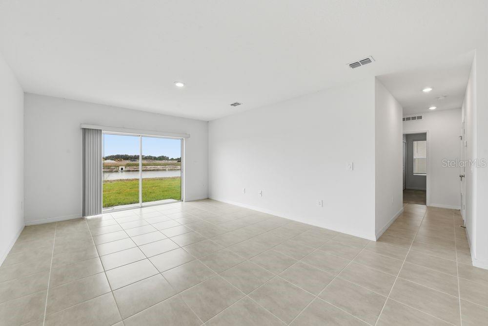 13231 Commons Avenue Parrish, FL 34219 - Photo 8 of 40 a view of an empty room with a kitchen and a window